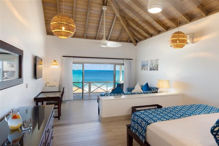 A premium beachfront suite with ocean views at Galley Bay Resort & Spa