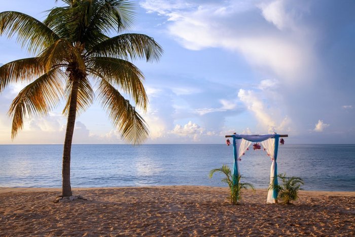 A couple renewing their vows in a beachfront gazebo at Galley Bay Resort & Spa Antigua