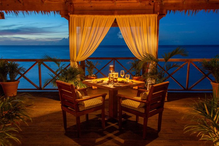 An open-air massage hut overlooking the lagoon at Indulge Spa, Galley Bay Resort & Spa