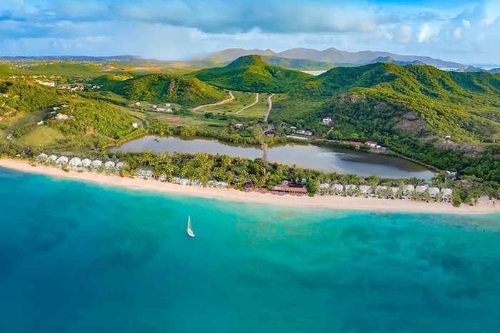 A serene tropical beach and lagoon view at Galley Bay Resort & Spa