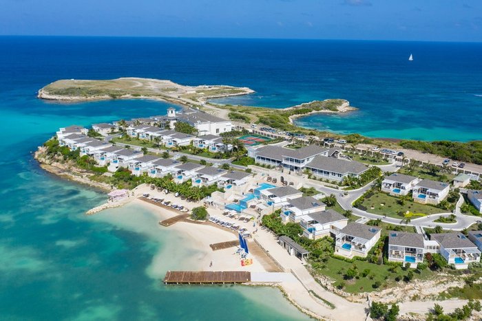 An aerial view of Hammock Cove Antigua's white-sand beach and turquoise bay