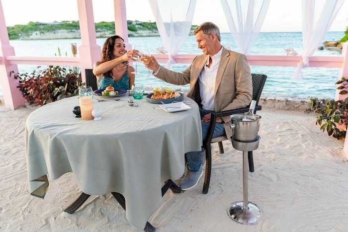 A sunset toast at private beachside dining at Hammock Cove Antigua