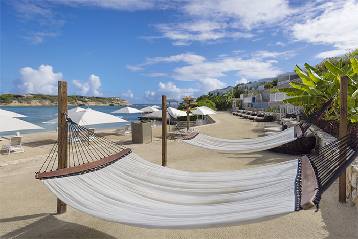 A couple enjoying the private plunge pool with ocean views at Hammock Cove Antigua