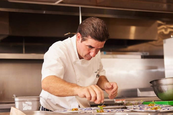 A chef plating Michelin-caliber cuisine at Hammock Cove Antigua
