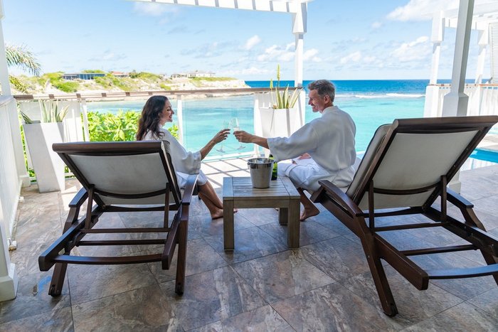 A couple enjoying drinks at the Lighthouse Bar at Hammock Cove Antigua