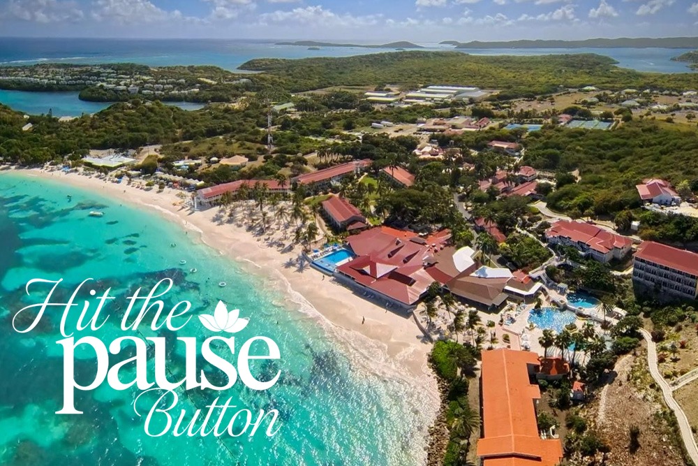 Aerial view of the quarter-mile white-sand beach and turquoise water at Pineapple Beach Club Antigua