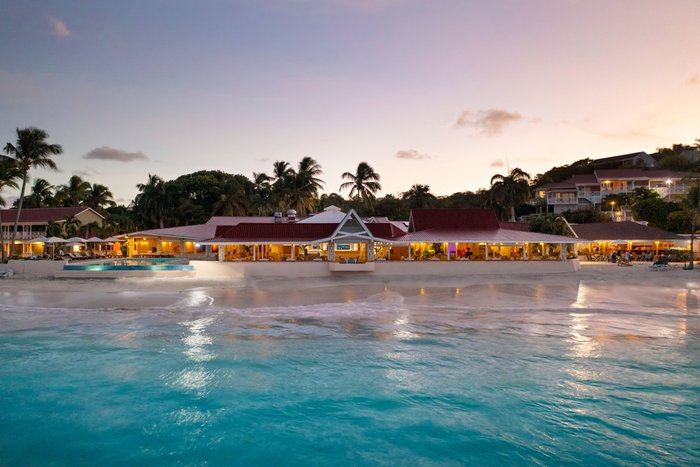 The pool terrace lit at night at Pineapple Beach Club Antigua