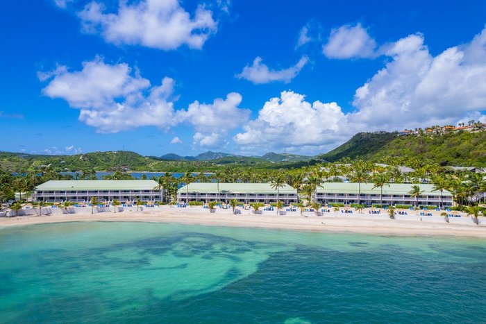 Palm trees and lounge chairs on Coco's Beach at St. James's Club Antigua