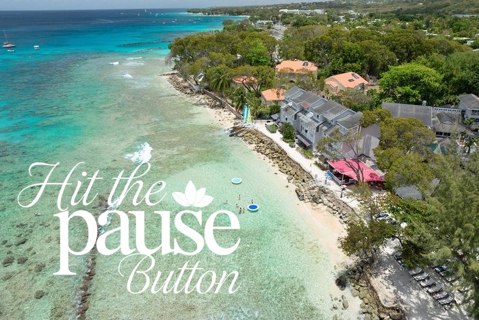 Aerial view of the white-sand beach and turquoise bay at The Club Barbados