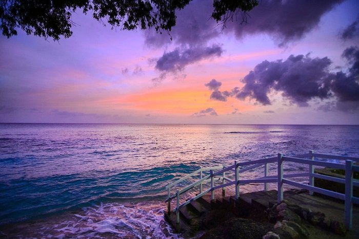 A sailboat drifting on the Caribbean at sunset off The Club Barbados