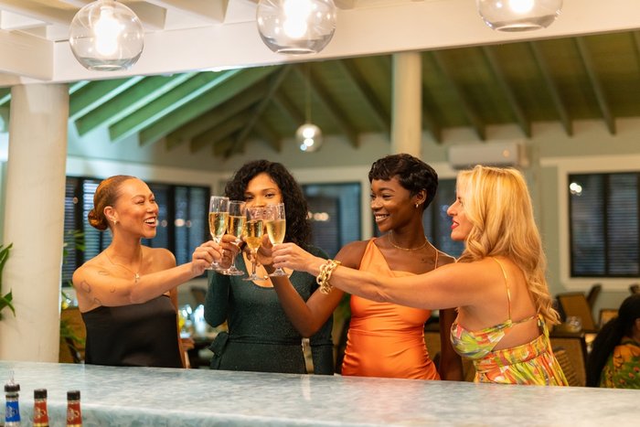 Women toasting drinks on a girlfriends getaway at The Verandah Antigua