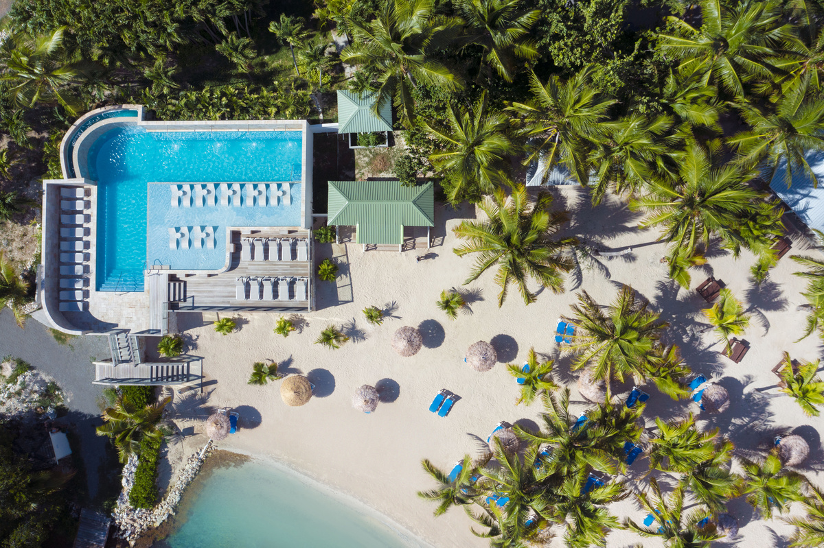 An aerial view of The Verandah Antigua wrapped in tropical gardens above the Caribbean