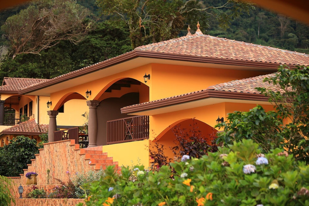 A terracotta-roofed casita and gardens in golden hour at Los Establos Boutique Resort Panama