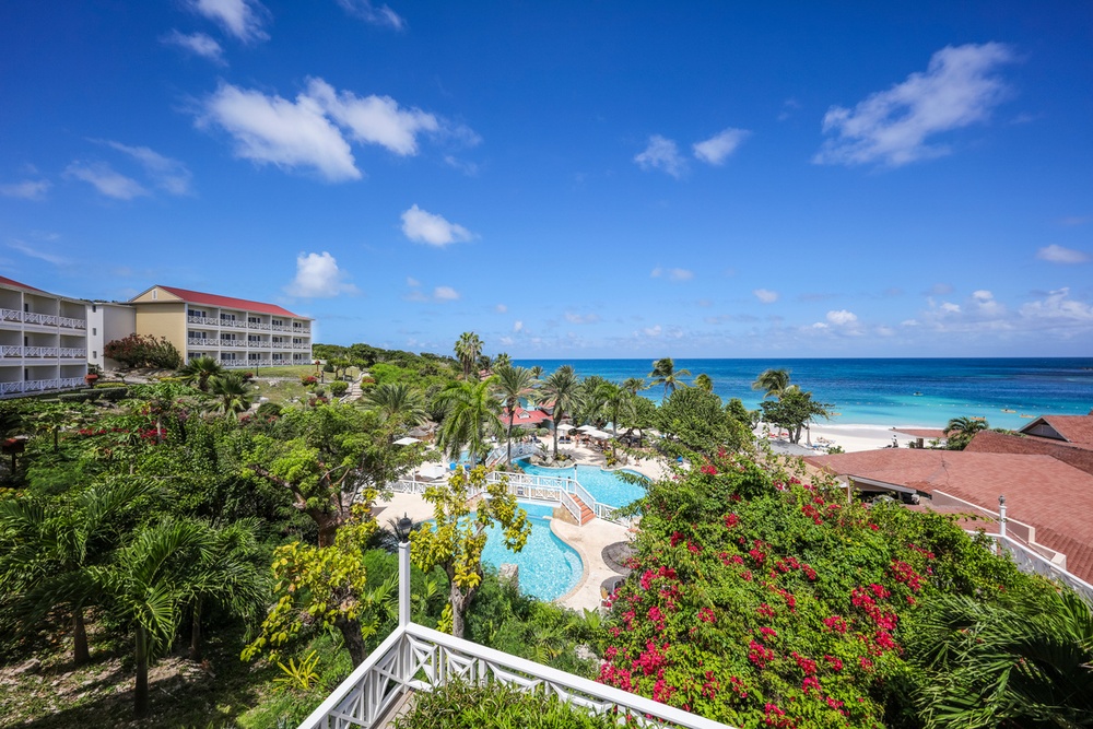 Pool, beach, and tropical gardens at Pineapple Beach Club Antigua