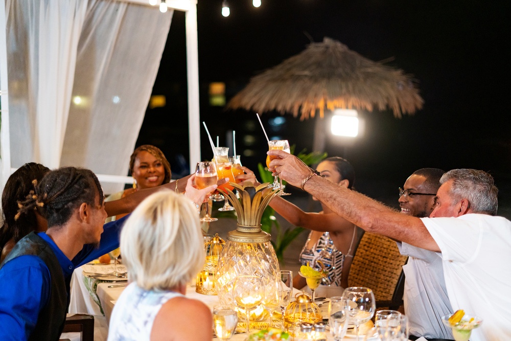 A couple raising a glass to a special occasion at Pineapple Beach Club Antigua