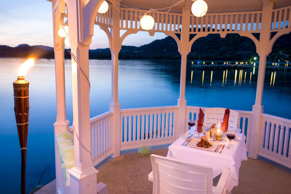 A couple raising a glass to a special occasion at St. James's Club Antigua