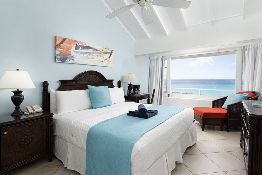 Aerial of the pool, palms, and oceanfront at The Club Barbados