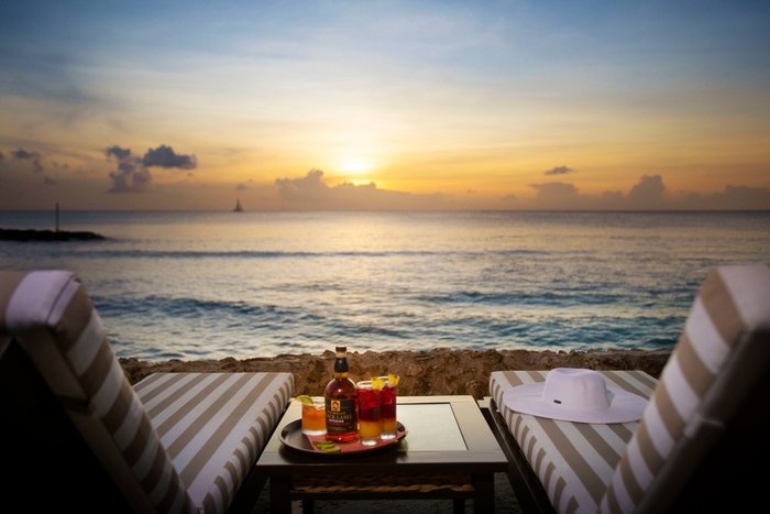 A romantic oceanfront terrace at sunset at The Club Barbados