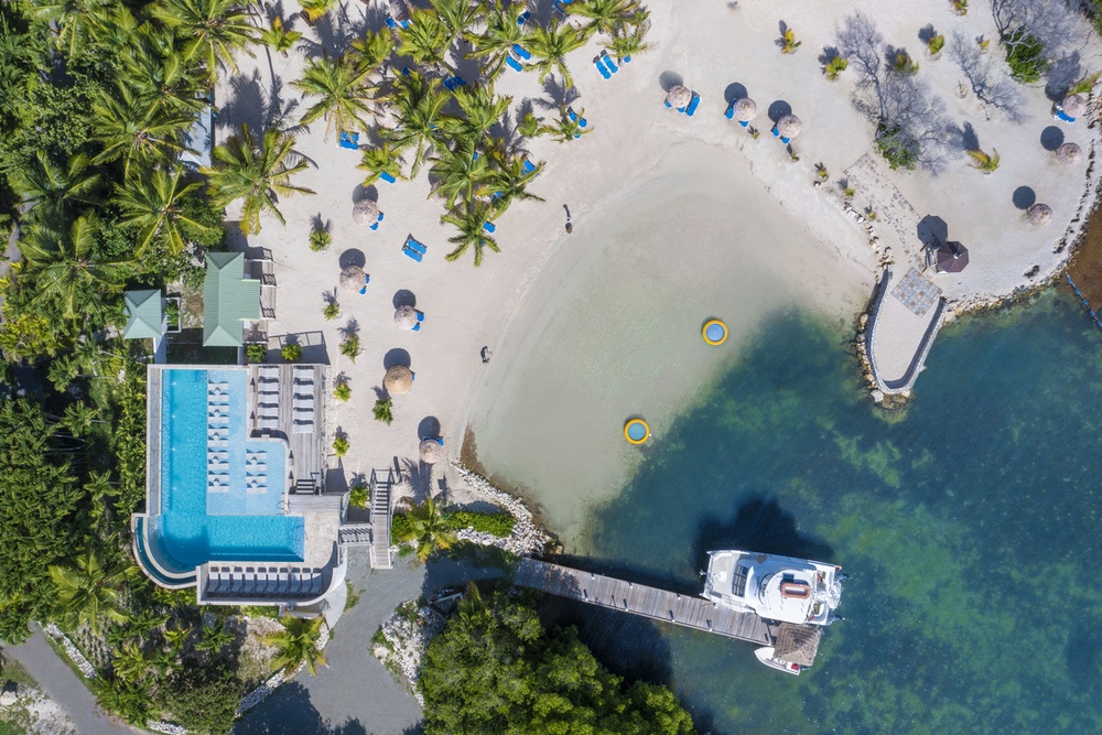 An aerial sunset view of the pool and pier at The Verandah Antigua